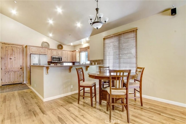 26371 Spyglass Dr, Lake Arrowhead, CA 92352 - dining area featuring high vaulted ceiling, light wood-style flooring, recessed lighting, a notable chandelier, and baseboards
