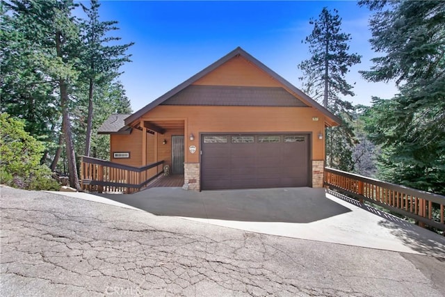 26371 Spyglass Dr, Lake Arrowhead, CA 92352 - rustic home with a garage, driveway, and stone siding