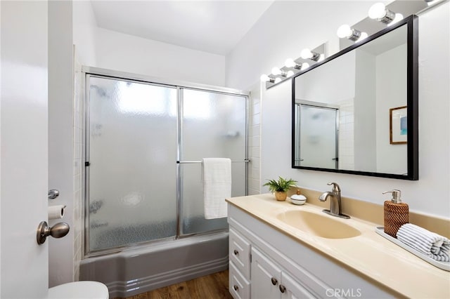 5263 E Paoli Way, Long Beach, CA 90803 - full bathroom featuring toilet, vanity, wood finished floors, and shower / bath combination with glass door