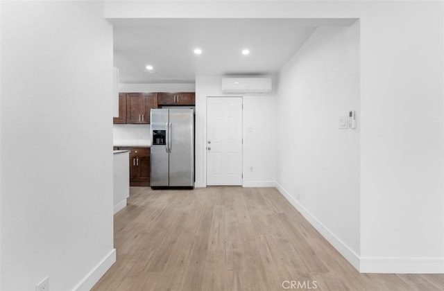 840 W 115th St, Los Angeles, CA 90044 - kitchen featuring stainless steel fridge, a wall unit AC, baseboards, light wood finished floors, and recessed lighting