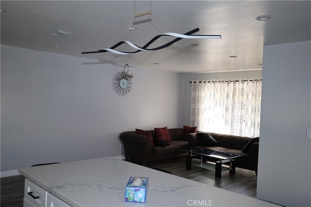 living room featuring wood finished floors, visible vents, and recessed lighting