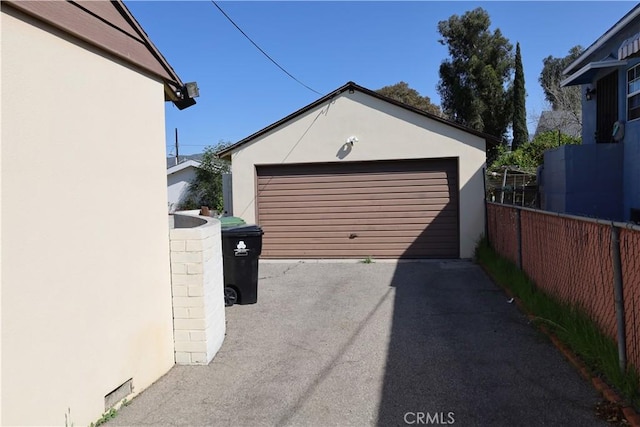 detached garage featuring fence