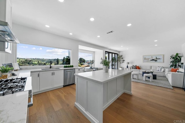 3792 Vista Pt, Bonita, CA 91902 - kitchen with appliances with stainless steel finishes, a sink, a center island, recessed lighting, and white cabinets