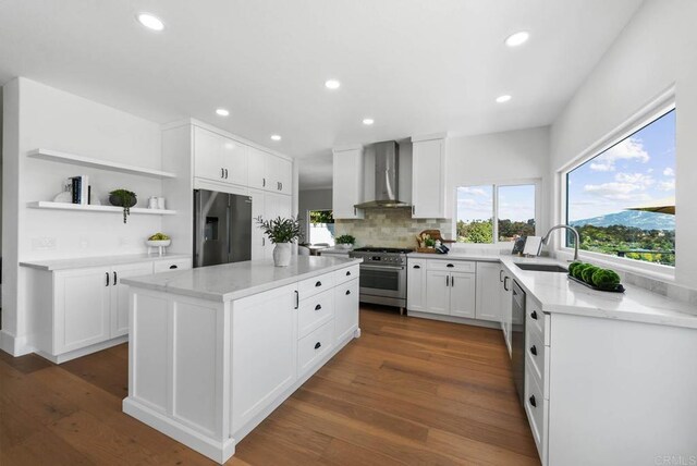 3792 Vista Pt, Bonita, CA 91902 - kitchen featuring appliances with stainless steel finishes, wall chimney range hood, a sink, open shelves, and a center island