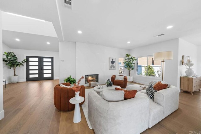 3792 Vista Pt, Bonita, CA 91902 - living area with wood finished floors, french doors, recessed lighting, a large fireplace, and baseboards