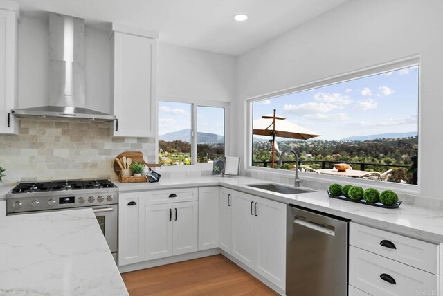 3792 Vista Pt, Bonita, CA 91902 - kitchen with wall chimney exhaust hood, appliances with stainless steel finishes, a mountain view, a sink, and white cabinetry