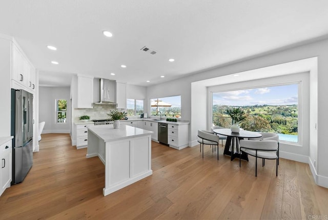 3792 Vista Pt, Bonita, CA 91902 - kitchen featuring stainless steel appliances, wall chimney range hood, plenty of natural light, a center island, and recessed lighting