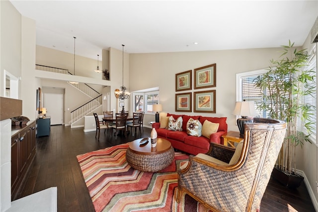 1525 Elegante Ct, Corona, CA 92882 - living room featuring stairs, dark wood-style flooring, high vaulted ceiling, a chandelier, and baseboards