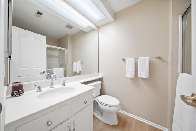 1525 Elegante Ct, Corona, CA 92882 - full bathroom featuring a stall shower, toilet, wood finished floors, vanity, and baseboards