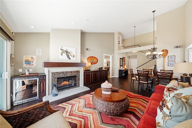 1525 Elegante Ct, Corona, CA 92882 - living area with wood finished floors, stairs, baseboards, beverage cooler, and a towering ceiling