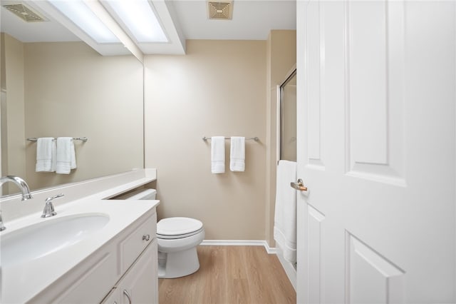 1525 Elegante Ct, Corona, CA 92882 - bathroom featuring wood finished floors, toilet, vanity, a shower, and baseboards