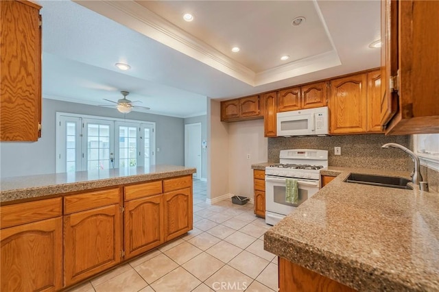 7041 Heil Ave, Huntington Beach, CA 92647 - kitchen featuring ornamental molding, white appliances, brown cabinetry, a raised ceiling, and a sink