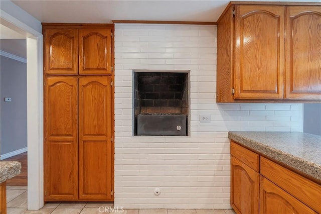 7041 Heil Ave, Huntington Beach, CA 92647 - kitchen featuring crown molding, backsplash, brown cabinetry, and light tile patterned flooring