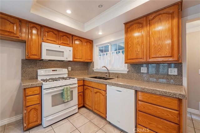 7041 Heil Ave, Huntington Beach, CA 92647 - kitchen with a sink, a tray ceiling, brown cabinetry, and white appliances