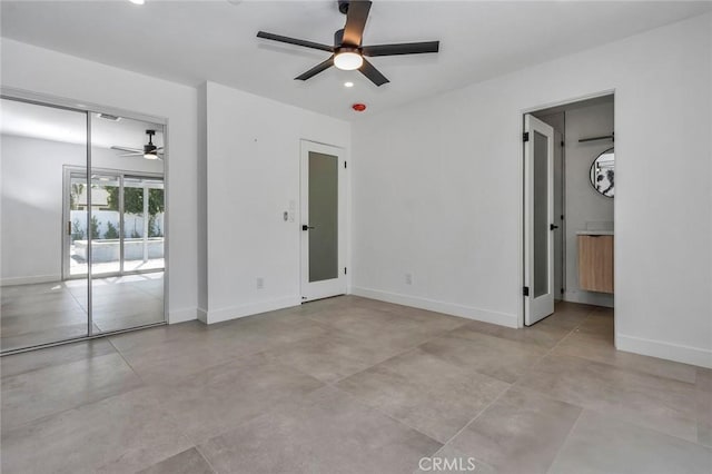 2175 N Sandra Rd, Palm Springs, CA 92262 - unfurnished bedroom with baseboards, access to exterior, ensuite bathroom, and a ceiling fan
