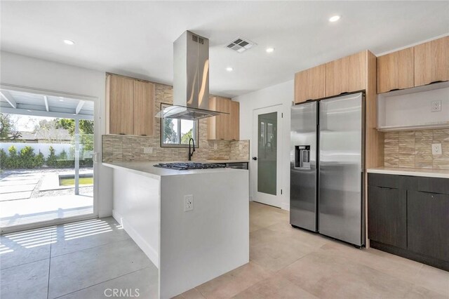 2175 N Sandra Rd, Palm Springs, CA 92262 - kitchen featuring stainless steel fridge with ice dispenser, island exhaust hood, backsplash, light countertops, and recessed lighting