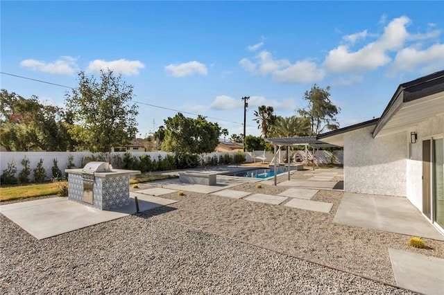 2175 N Sandra Rd, Palm Springs, CA 92262 - view of pool with an outdoor kitchen, a patio, a pergola, and a fenced backyard