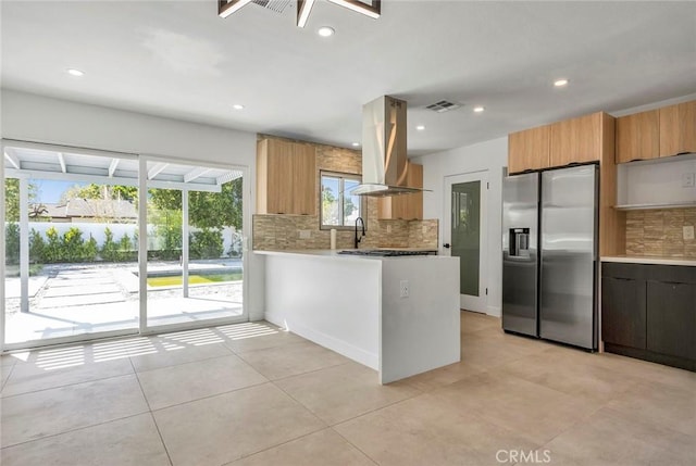 2175 N Sandra Rd, Palm Springs, CA 92262 - kitchen featuring stainless steel refrigerator with ice dispenser, island exhaust hood, backsplash, a peninsula, and recessed lighting