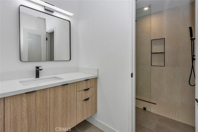 2175 N Sandra Rd, Palm Springs, CA 92262 - bathroom featuring tile patterned floors, a walk in shower, vanity, and baseboards