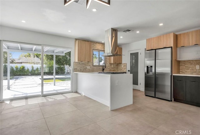 2175 N Sandra Rd, Palm Springs, CA 92262 - kitchen featuring stainless steel refrigerator with ice dispenser, island range hood, tasteful backsplash, a peninsula, and recessed lighting