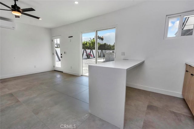 2175 N Sandra Rd, Palm Springs, CA 92262 - kitchen featuring a peninsula, healthy amount of natural light, a wall unit AC, light countertops, and recessed lighting