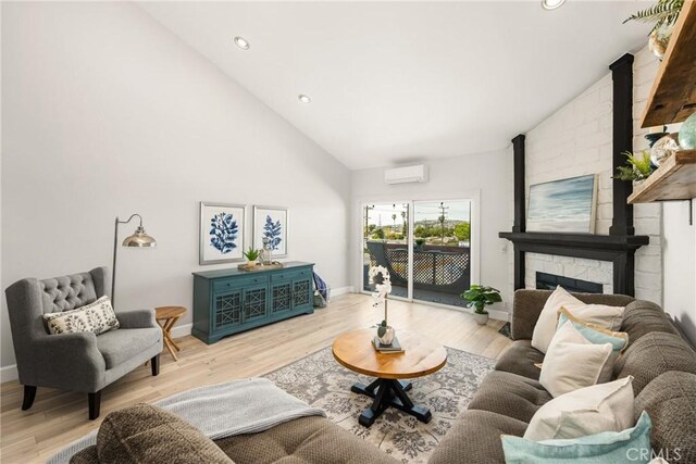 3600 E 4th St Unit 303, Long Beach, CA 90814 - living area featuring a wall mounted AC, light wood-style floors, baseboards, high vaulted ceiling, and recessed lighting