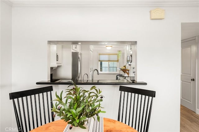 3600 E 4th St Unit 303, Long Beach, CA 90814 - dining room with crown molding and light wood finished floors