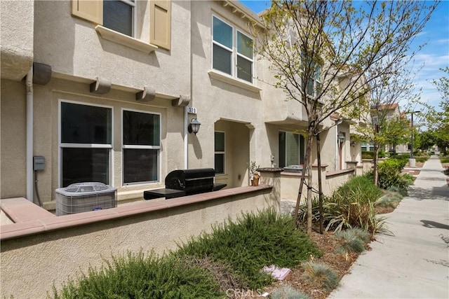 exterior space featuring central AC and stucco siding