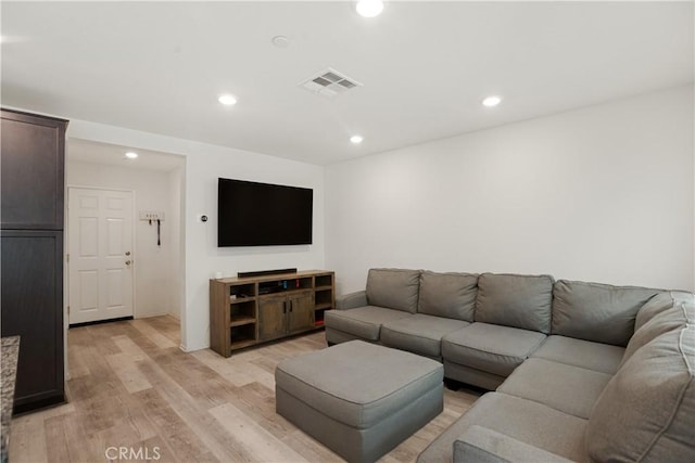 living room with recessed lighting, visible vents, and light wood-style floors