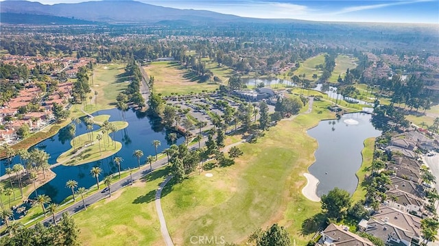 birds eye view of property with a water and mountain view