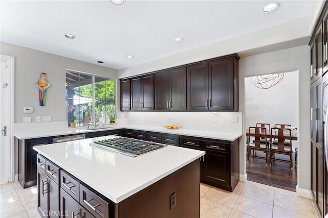 12475 Woodhall Way, Tustin, CA 92782 - kitchen with stainless steel gas stovetop, light tile patterned floors, light countertops, dark brown cabinetry, and recessed lighting