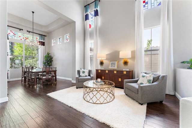 interior space featuring baseboards, a high ceiling, and wood finished floors