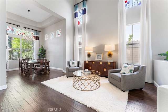 12475 Woodhall Way, Tustin, CA 92782 - living area featuring a towering ceiling, wood finished floors, baseboards, and a chandelier