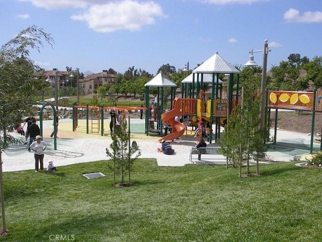 community jungle gym featuring a lawn