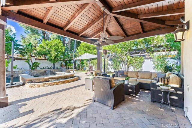 view of patio featuring an outdoor hangout area, a fenced backyard, and a ceiling fan