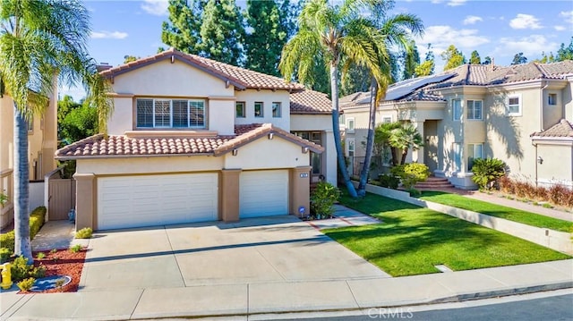 mediterranean / spanish house featuring a tiled roof, concrete driveway, and stucco siding