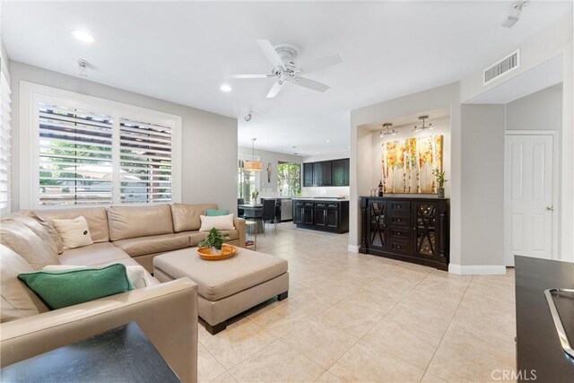 living area featuring visible vents, light tile patterned floors, baseboards, ceiling fan, and recessed lighting