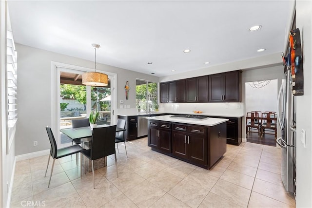 kitchen featuring pendant lighting, dark brown cabinets, recessed lighting, appliances with stainless steel finishes, and light countertops