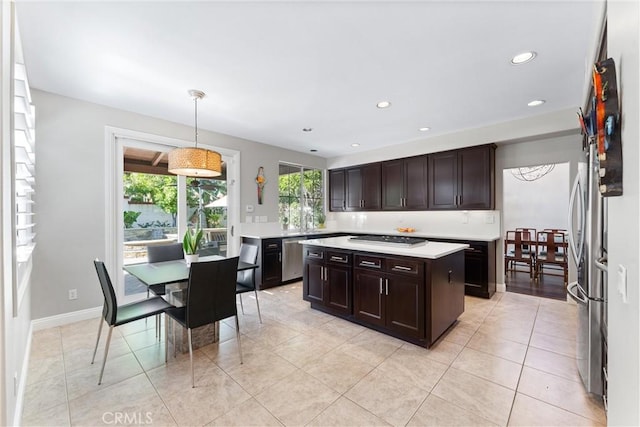 12475 Woodhall Way, Tustin, CA 92782 - kitchen with light countertops, dark brown cabinetry, recessed lighting, pendant lighting, and light tile patterned flooring