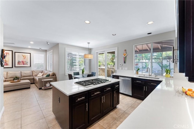 kitchen with recessed lighting, light tile patterned floors, light countertops, stainless steel appliances, and a sink