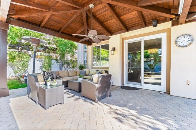 view of patio with an outdoor living space and a ceiling fan