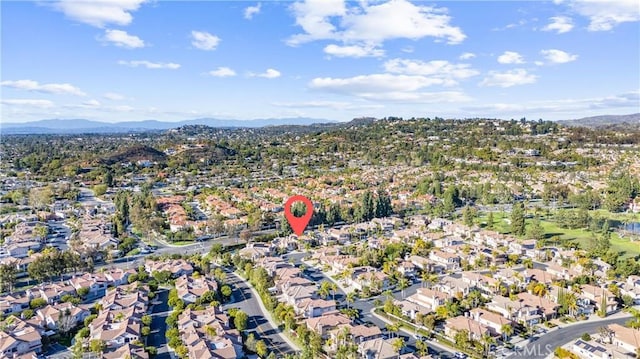 drone / aerial view featuring a residential view and a mountain view