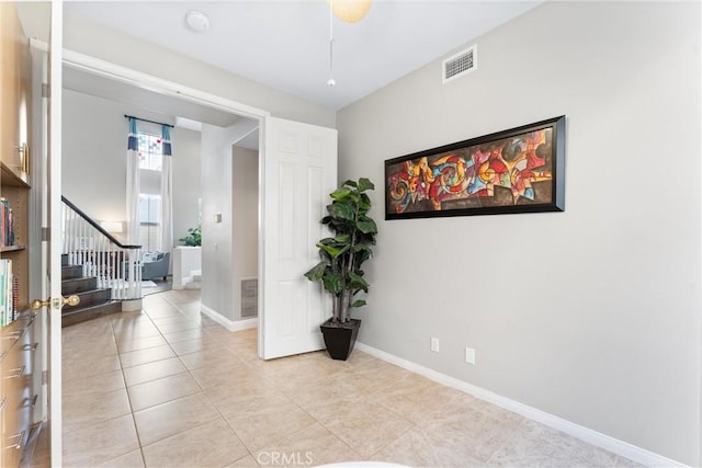 12475 Woodhall Way, Tustin, CA 92782 - hall with stairway, light tile patterned floors, and baseboards