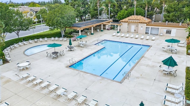 pool featuring fence and a patio