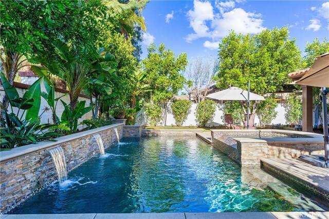 view of pool with a fenced backyard