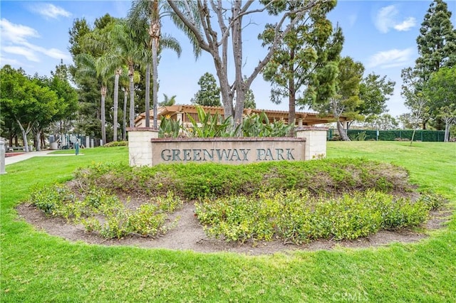 community / neighborhood sign with a yard