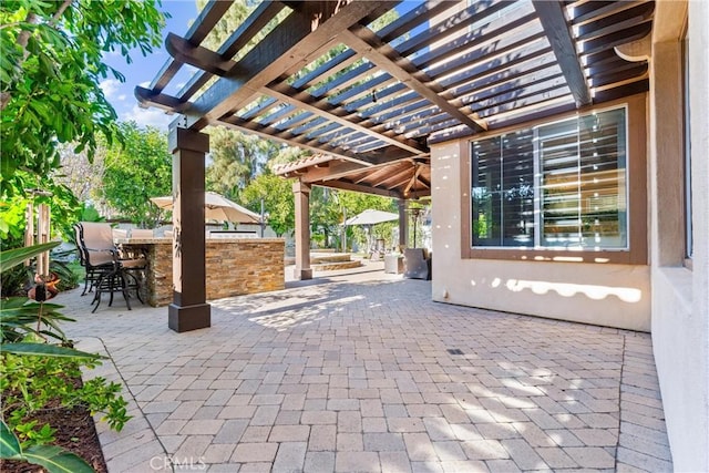 view of patio featuring outdoor dry bar and a pergola