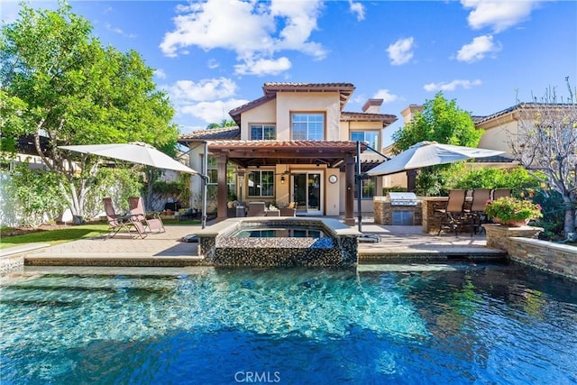 12475 Woodhall Way, Tustin, CA 92782 - rear view of property featuring exterior kitchen, a patio area, a tile roof, stucco siding, and a pool with connected hot tub