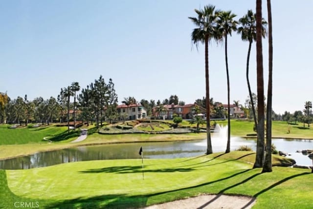 surrounding community featuring a water view, golf course view, and a yard