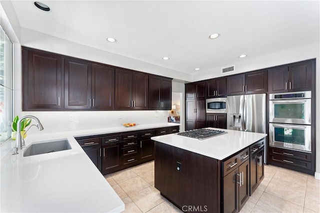 kitchen featuring visible vents, a sink, light countertops, appliances with stainless steel finishes, and light tile patterned flooring